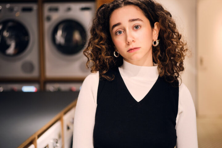 curly-haired woman at laundromat