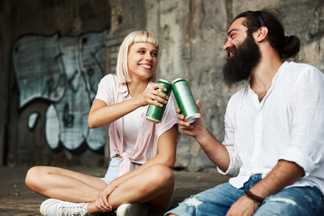 couple having beer at skate park