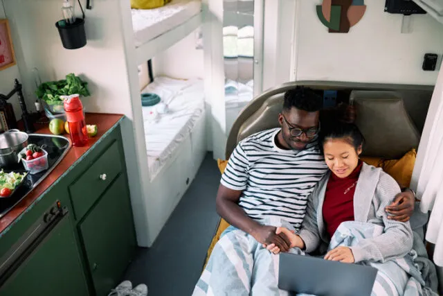 couple cuddling in camper van