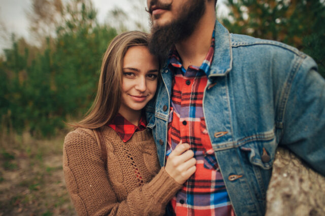 couple cuddling in forest